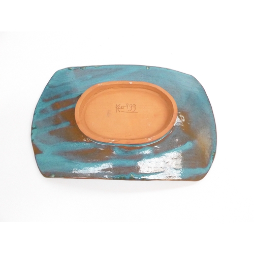 7126 - A studio pottery slab built dish with impressed motifs signed to base Kaori '99 33x21cm