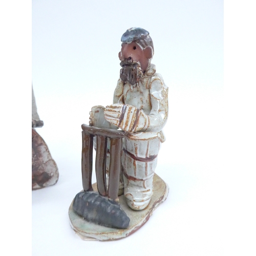 7081 - Two Seven Springs pottery figures in a boat and a cricketer. Labelled. Tallest 21cm