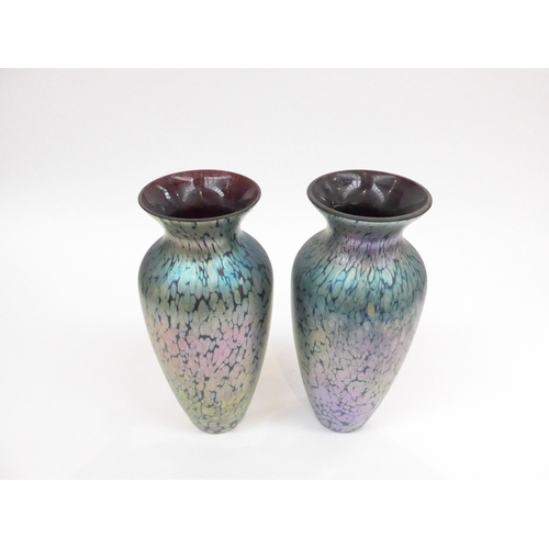 7323 - A pair of Okra art glass vases with mottled iridescent design. Labelled 22.5cm high