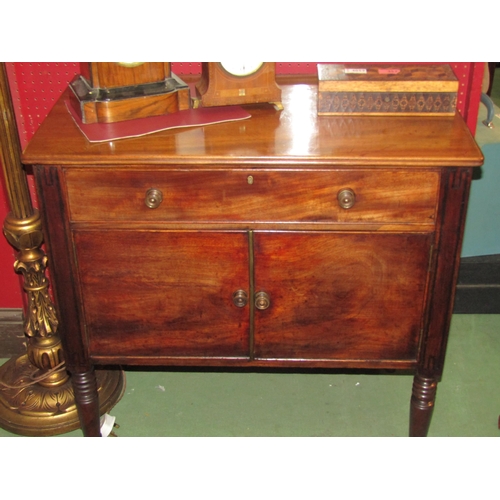 4060 - A George III mahogany side cabinet, the single drawer over two cupboard doors on ring-turned taperin... 