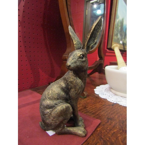 4080 - A bronzed resin statue of a sitting hare, 22cm tall