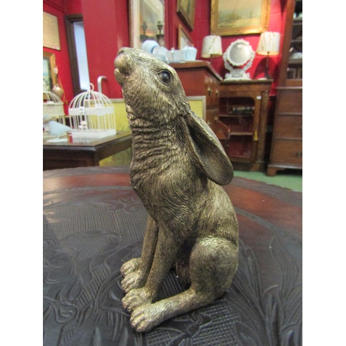 4107 - A bronzed resin statuette of a moon gazing hare, 18cm tall