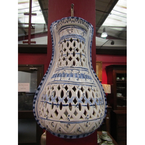 4111 - A Delft-style blue-and-white ceramic wall-hanging candle sconce with pierced pattern, 36cm tall