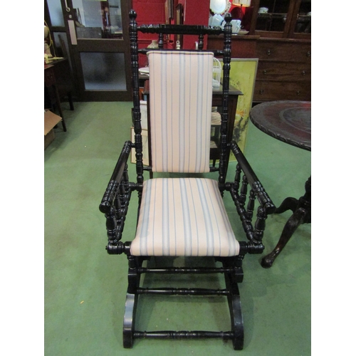 4115 - A circa 1900 ebonised American rocking chair with ring-turned decoration