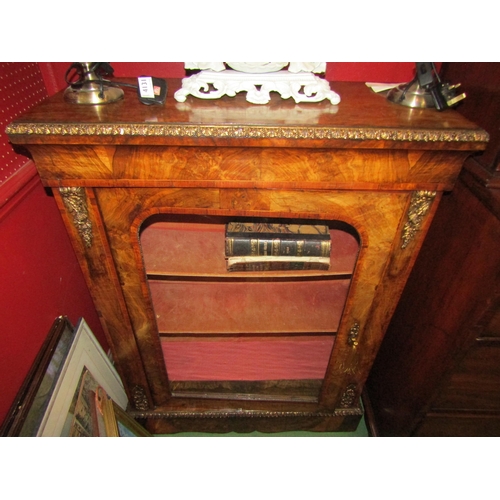 4134 - A mid Victorian figured walnut pier cabinet with gilt ormolu mounts, the single glazed door with key... 