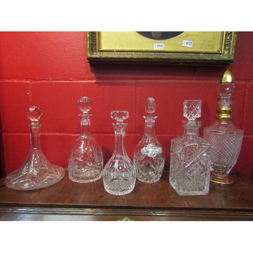 4142 - Six cut glass decanters of various forms, one with gilt decoration and another with a white metal sh... 