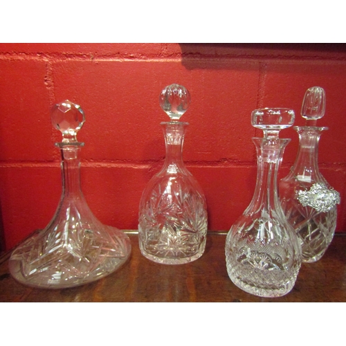 4142 - Six cut glass decanters of various forms, one with gilt decoration and another with a white metal sh... 