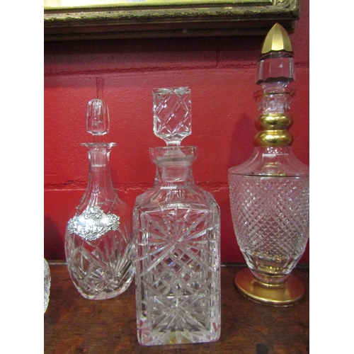 4142 - Six cut glass decanters of various forms, one with gilt decoration and another with a white metal sh... 