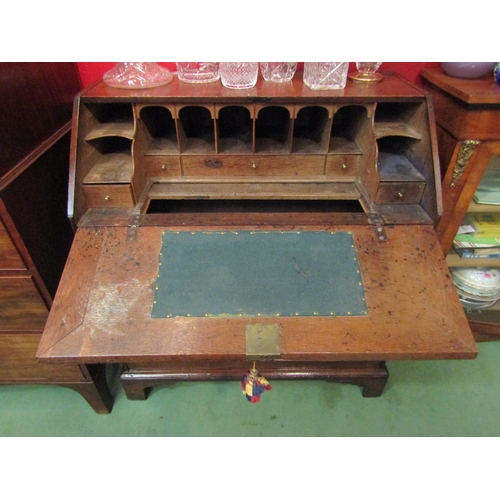 4143 - A George III country oak bureau, the fitted interior with document well over two short and two long ... 