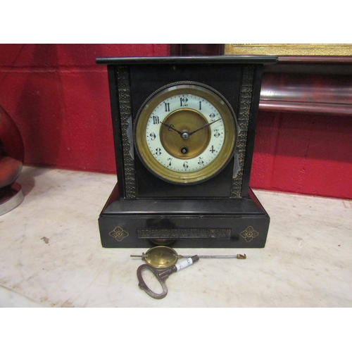 4164 - A circa 1900 black slate mantel clock with Roman chapter ring and gilt brass face, some damage prese... 