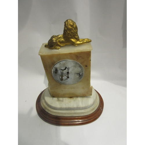 4447 - A French alabaster mantel clock, Arabic numerated chaptering a/f surmounted by recumbent lion on ass... 