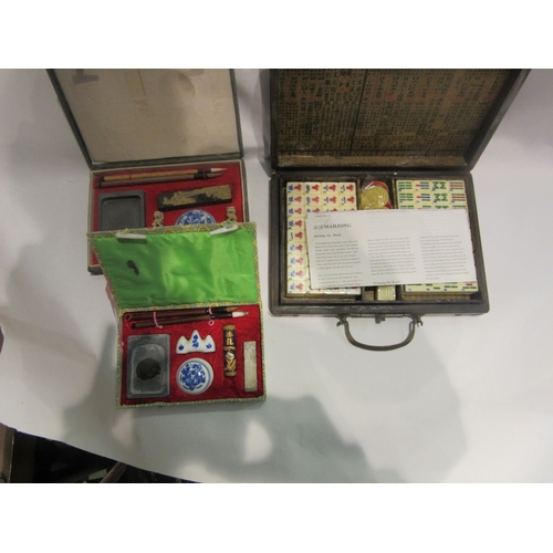 4448 - A cased Mahjong set, brand new still wrapped pieces, together with two calligraphy sets and Oriental... 