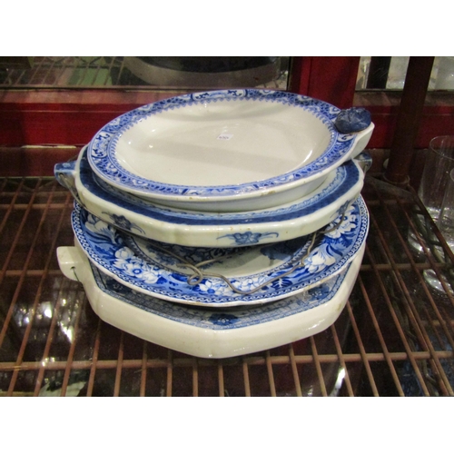 4463 - Four ceramic 19th Century blue and white ceramic warming plates, various patterns