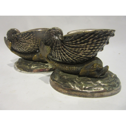 4486 - A pair of 19th Century cast metal table salts in the form of nautilus shell on the back of a dolphin... 