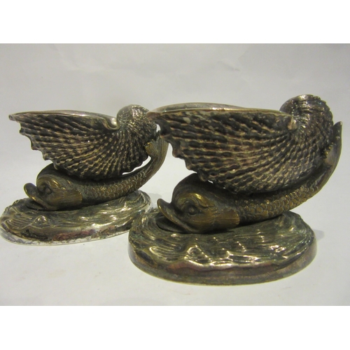 4486 - A pair of 19th Century cast metal table salts in the form of nautilus shell on the back of a dolphin... 