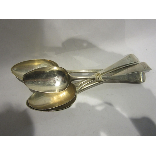 4491 - Four George III silver serving spoons and another silver example all with monogrammed crest most wit... 