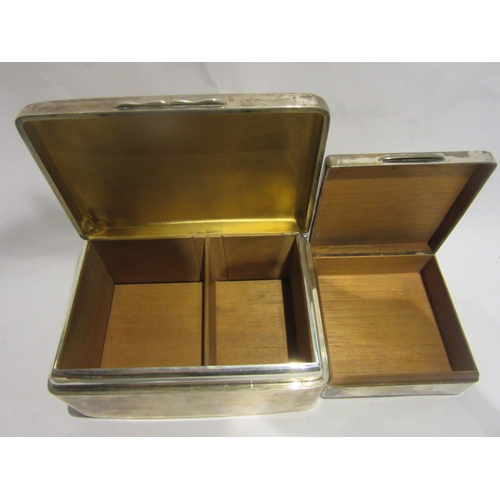 4492 - Two silver cigarette boxes both with dents and wood lined interiors.  6cm x 13.5cm and 3.5cm x 8.5cm... 