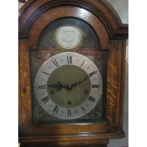 4010 - A 20th Century oak cased grandmother clock with 8 day movement and chime, silvered chapter ring, spa... 