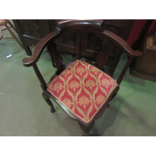 4012 - An Edwardian mahogany corner chair the scroll arms over pierced splat supports on pad foot cabriole ... 