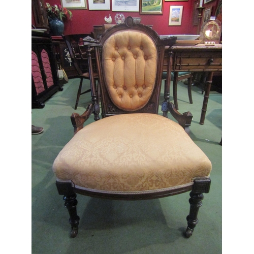 4070 - A Victorian style button back armchair with carved decoration