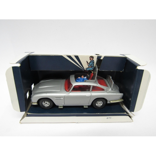 9411 - A Corgi diecast 271 James Bond Aston Martin DB5 (1:36 scale) in silver with red interior, with James... 