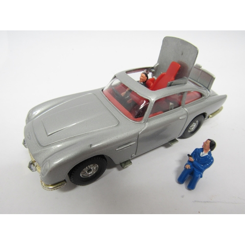 9411 - A Corgi diecast 271 James Bond Aston Martin DB5 (1:36 scale) in silver with red interior, with James... 