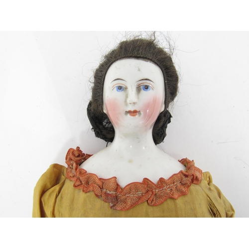 9260 - A 19th Century glazed china shoulder head doll with hand painted features including brown eyebrows, ... 