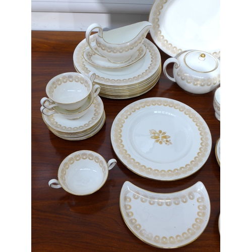 7039 - Eric Ravilious for Wedgwood - A collection of 'Golden Persephone' dinner and tea wares, some plain, ... 