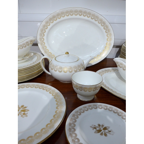 7039 - Eric Ravilious for Wedgwood - A collection of 'Golden Persephone' dinner and tea wares, some plain, ... 