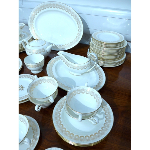 7039 - Eric Ravilious for Wedgwood - A collection of 'Golden Persephone' dinner and tea wares, some plain, ... 