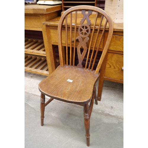 2087 - A 1920's elm seated wheel back side chair