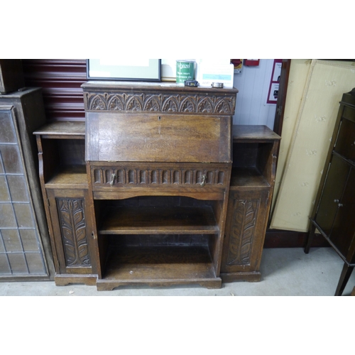 2114 - A carved oak side-by-side bureau bookcase