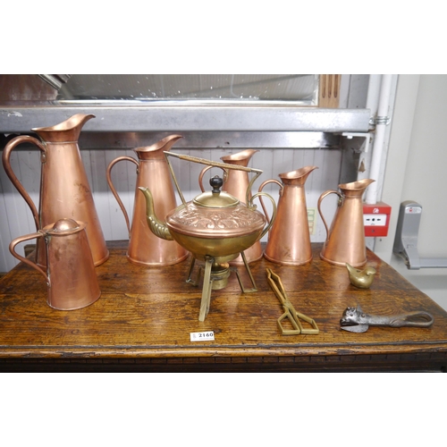 2162 - A quantity of copper and brass ware to include spirit kettle, jugs etc