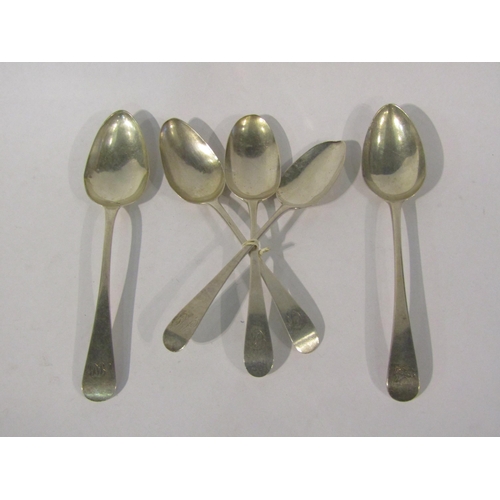 4491 - Four George III silver serving spoons and another silver example all with monogrammed crest most wit... 