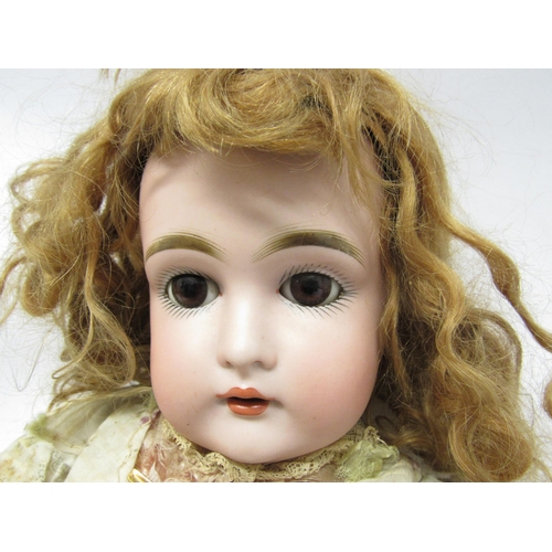 9237 - An early 20th Century bisque head doll in the manner of Kestner, with auburn wig, brown glass sleepi... 