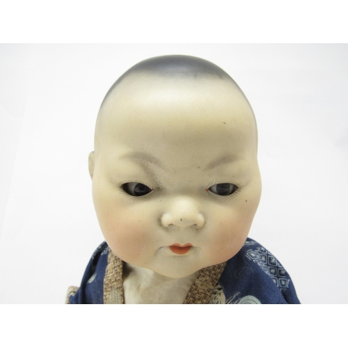 9262 - An early 20th Century Armand Marseille bisque head East Asian baby doll, with black painted hair, br... 