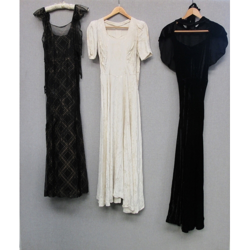 1057 - Two 1930's evening dresses, one in plain black bias cut velvet the dress has shoulder straps and an ... 