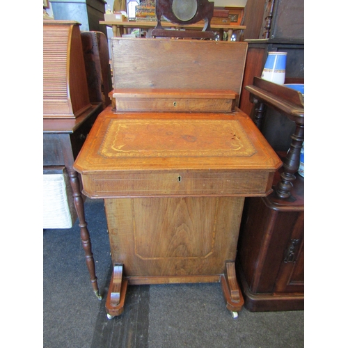 1100 - A Davenport with gilt tooled leather writing surface (a/f), four drawers with four faux drawers, on ... 