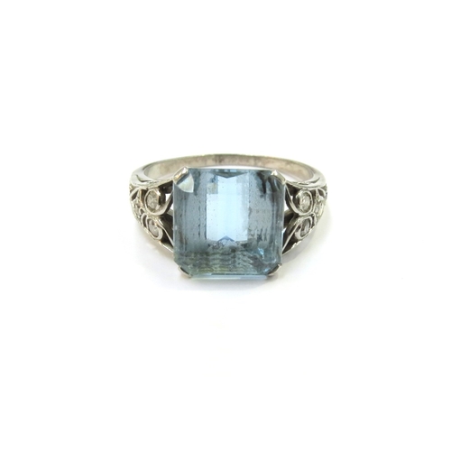 9056 - An Art Deco platinum ring with centre square cut aquamarine10mm x 10mm, open scroll shoulders set wi... 