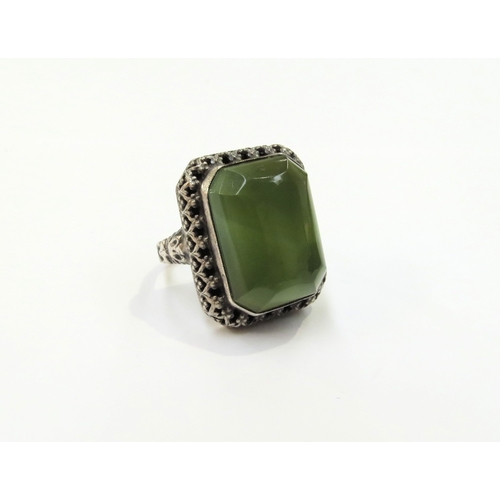 9371 - A Russian dress ring with large green cabochon, 2.4cm x 2cm