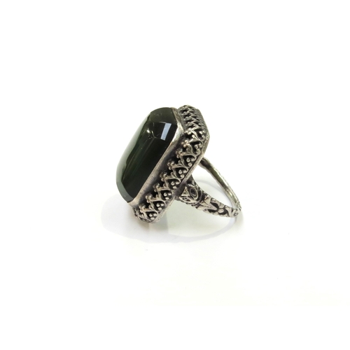 9371 - A Russian dress ring with large green cabochon, 2.4cm x 2cm