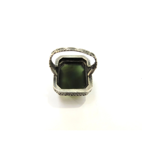 9371 - A Russian dress ring with large green cabochon, 2.4cm x 2cm