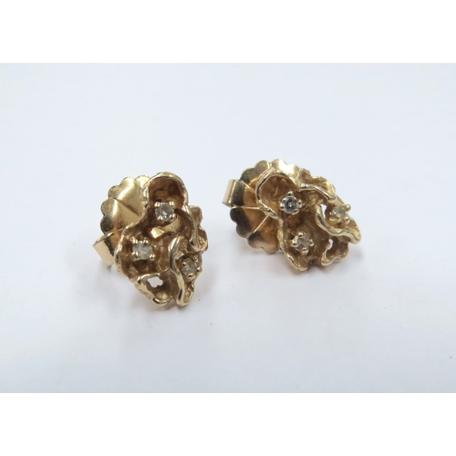 9025 - A pair of naturalistic form stud earrings set with three small diamonds, stamped 14k, 2.1g