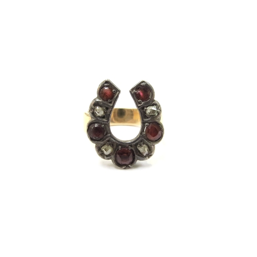 9332 - A horseshoe shaped ring set with alternating five rubies and four old cut diamonds, unmarked. Size E... 