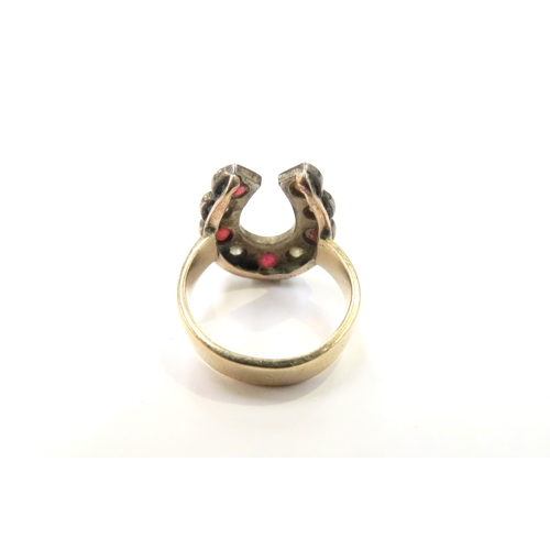 9332 - A horseshoe shaped ring set with alternating five rubies and four old cut diamonds, unmarked. Size E... 