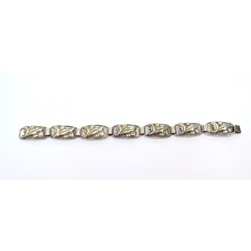 9415 - A Swedish silver bracelet, the seven panels with leaf and berries design, 18cm long