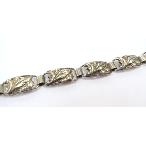 9415 - A Swedish silver bracelet, the seven panels with leaf and berries design, 18cm long