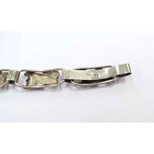 9415 - A Swedish silver bracelet, the seven panels with leaf and berries design, 18cm long