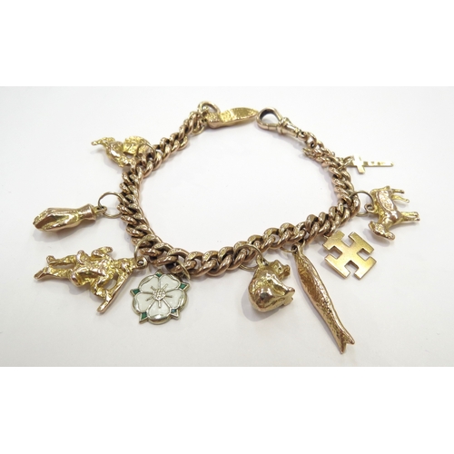 9071 - A 9ct gold charm bracelet, each link stamped 9c 375, 18cm long, hung with various charms some 9ct, 3... 