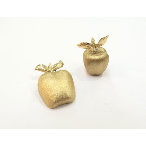 9065 - A brushed gold pendant as an apple with a single diamond to stalk, 7.6g and a brushed gold pendant a... 